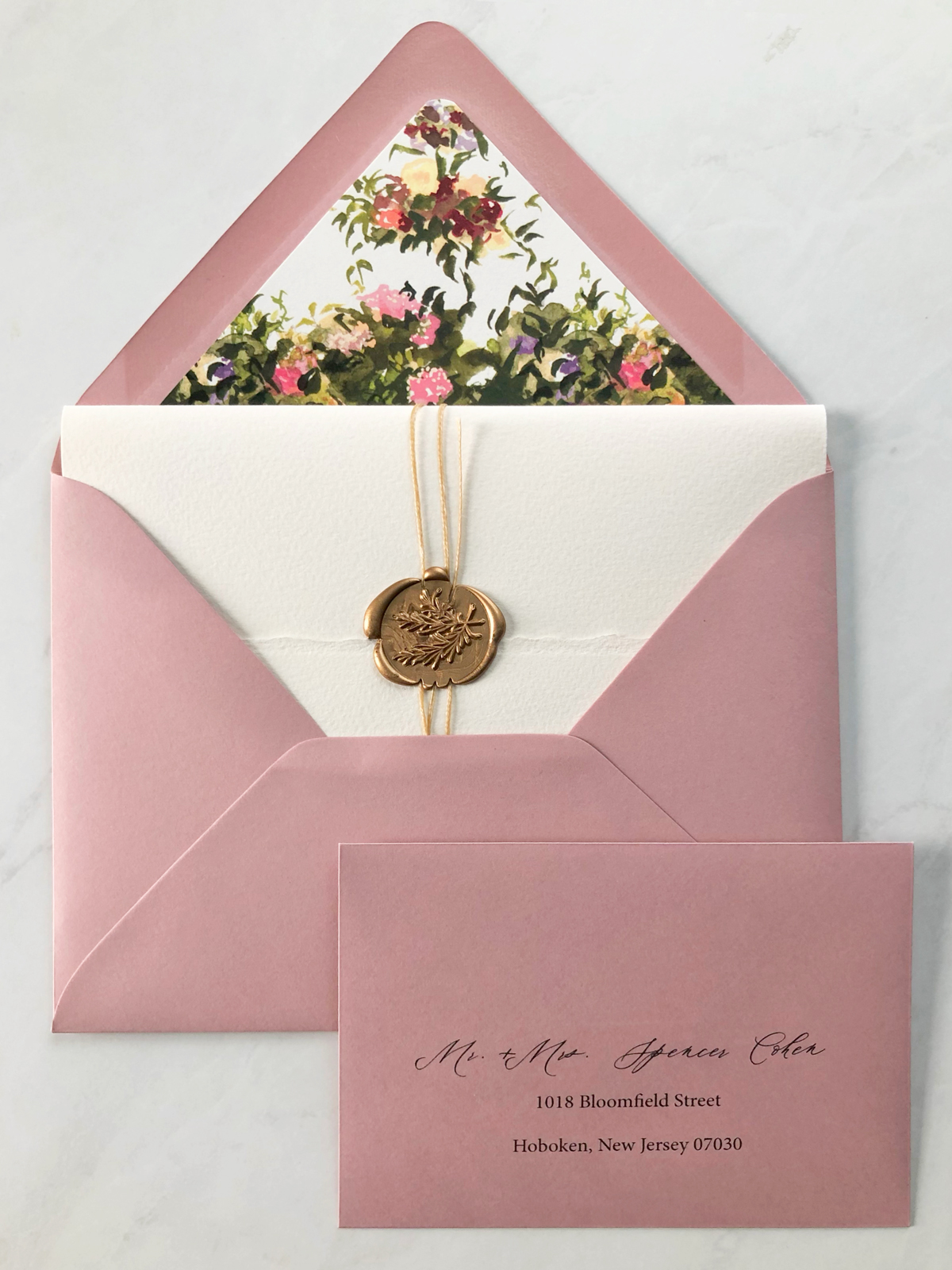 jolly edition wedding stationery: letterpress, wax seal, book binding, custom liner, and mauve envelope